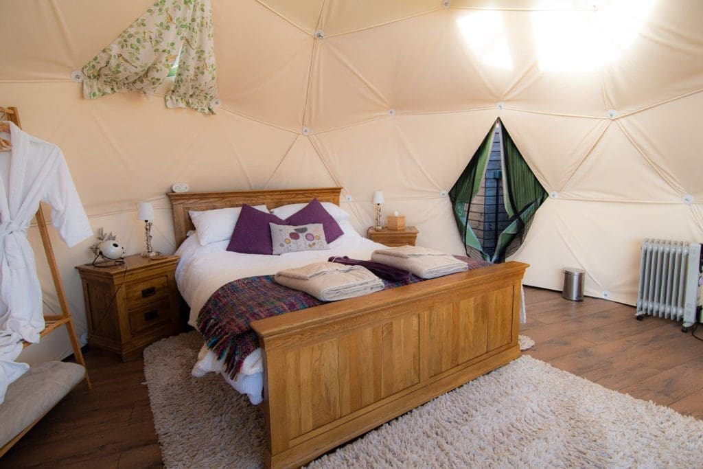 Luxury bed in glamping dome